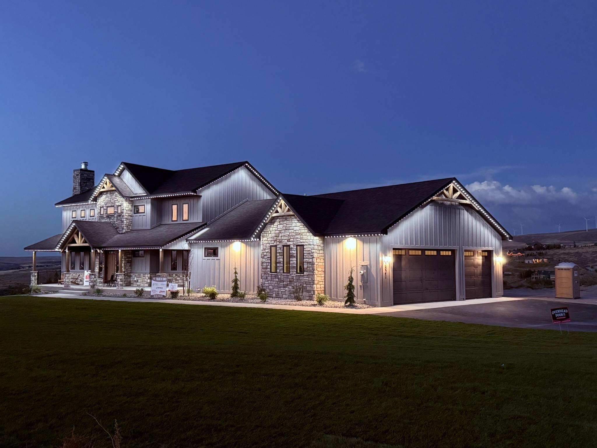 Home fully outlined in white permanent LED lighting at dusk