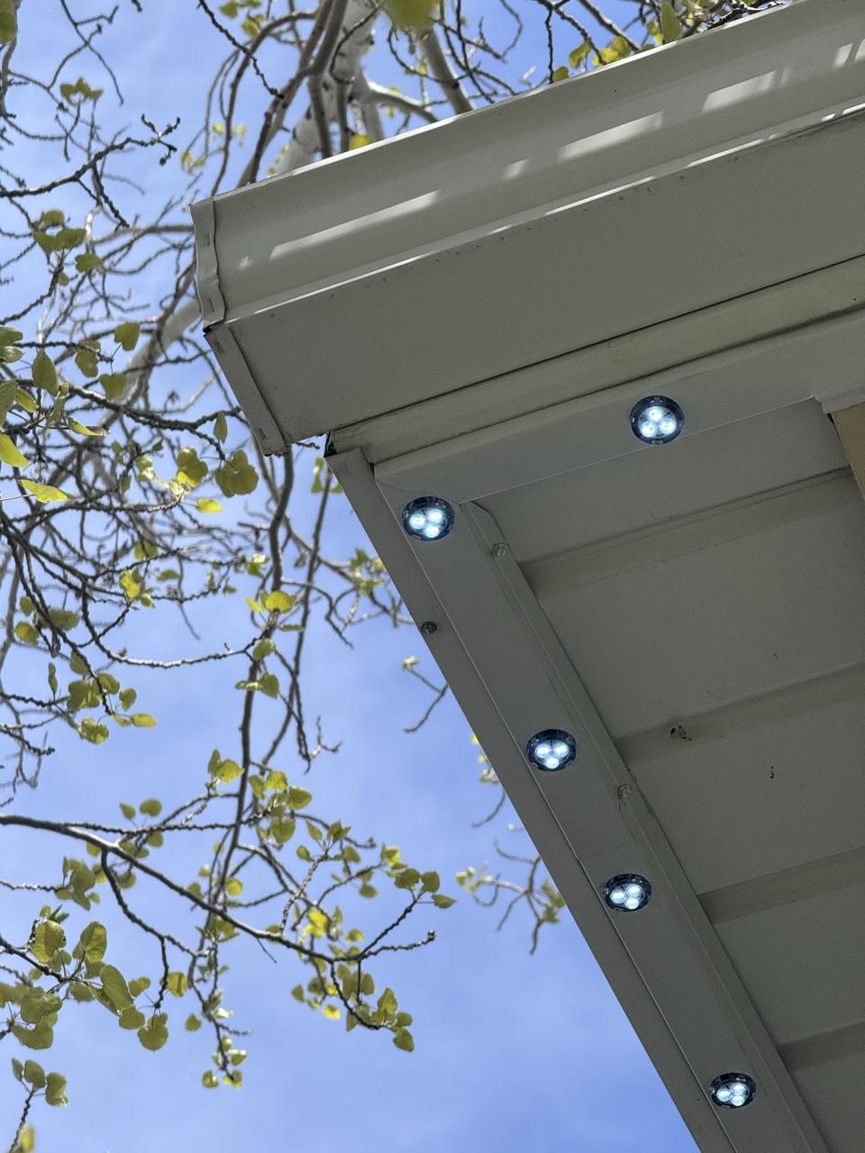 White GlowPros track with lit LED pucks at a roof corner