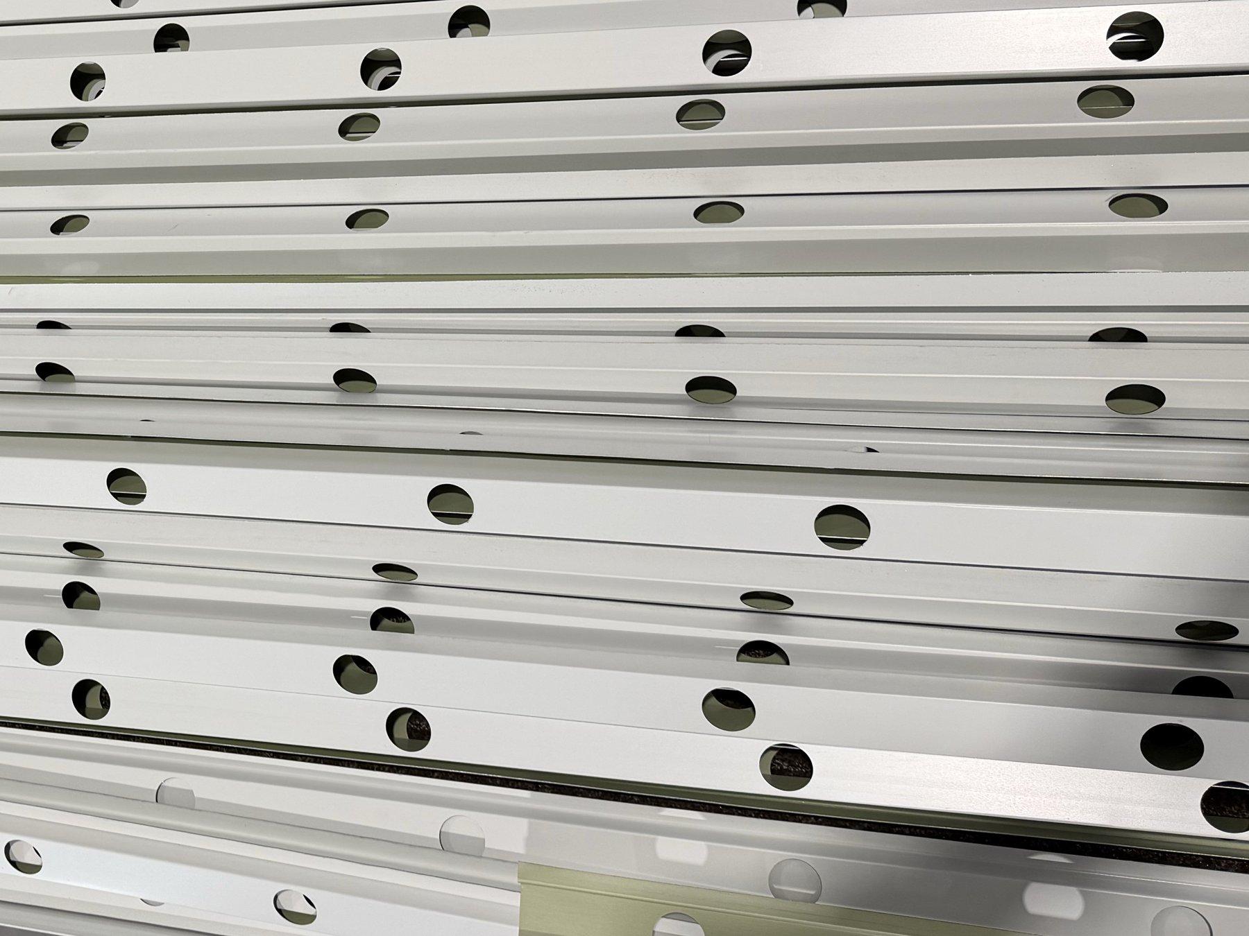 Stack of freshly rolled white GlowPros track with punched holes on the line in Idaho